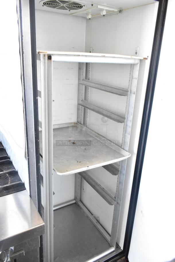 True TM-24 stainless steel commercial single door cooler with metal rack, on casters. Interior shows minor wear. 115V, 1 phase.