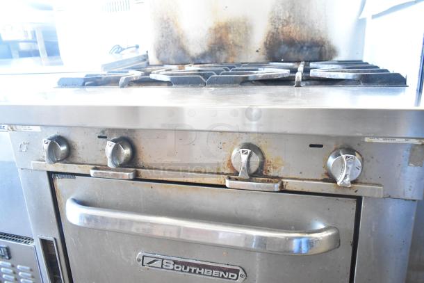 2016 Southbend P36D-XX stainless steel commercial 4 burner gas range with oven, showing signs of wear on knobs and backsplash.