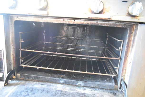 2016 Southbend P36D-XX stainless steel commercial range oven interior, showing rust and wear, with two racks installed.