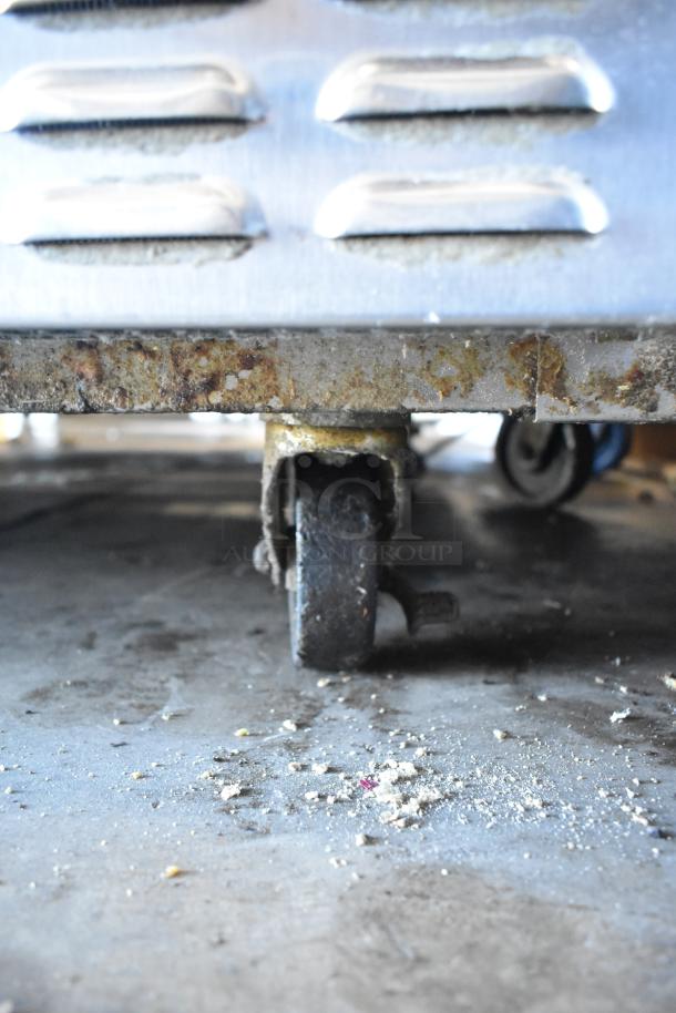 2017 Continental CPA68 stainless steel prep table with 2 drawers, 2 doors, on commercial casters. Some rust visible.