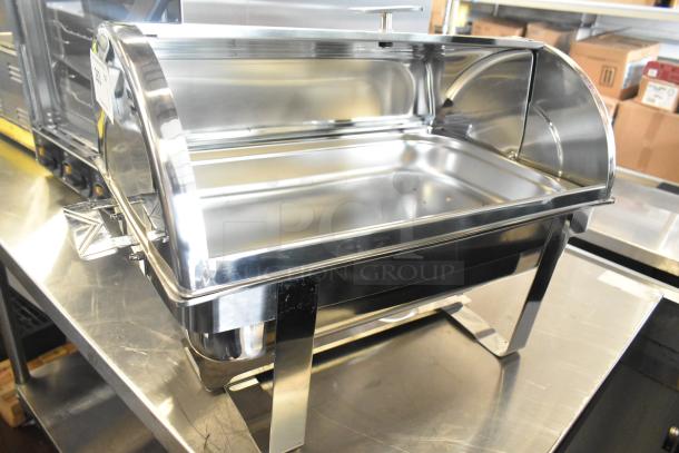 Brand new stainless steel chafing dish with scratches and dents visible, featuring a roll-top lid and sturdy frame.