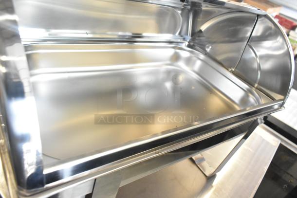 Brand new stainless steel chafing dish with minor scratches and dents. Shiny finish, ideal for buffet serving.