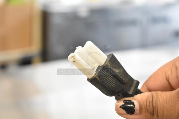 Close-up of a three-prong electrical plug for the Vollrath COV-120-HS convection oven. Plug shows minor wear.