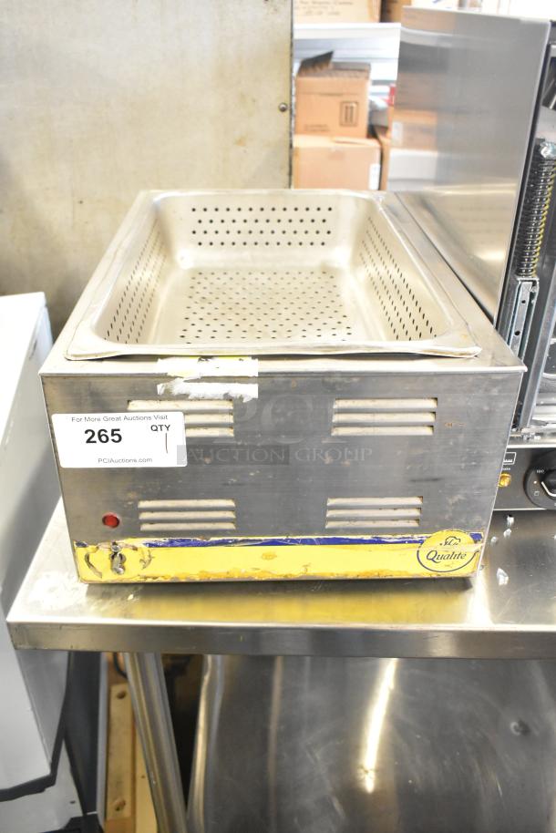 Qualite stainless steel commercial countertop food warmer, 115 volts, 1 phase. Visible wear, intact labels, perforated insert.