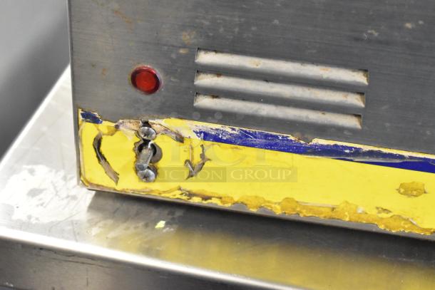 Qualite Stainless Steel Food Warmer, 115V, red indicator light, visible wear on yellow label, stainless steel exterior.