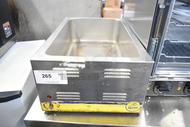 Qualite stainless steel countertop food warmer, 115V, 1 phase, used condition with visible wear. Auction tag 265.