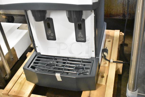 Brand new Scotsman HID312A-1A stainless steel countertop nugget ice machine and water dispenser with hands-free features.