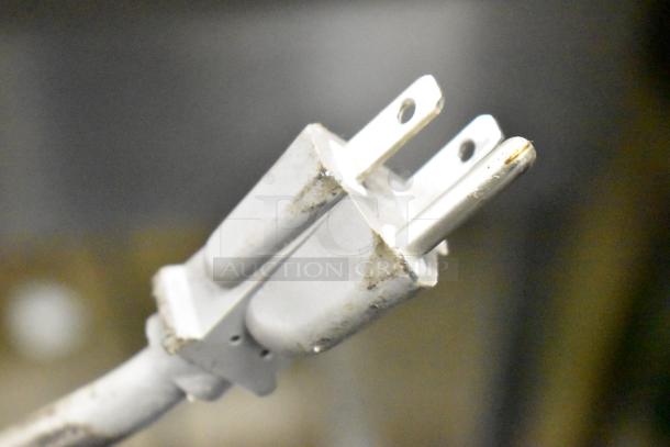 Two-prong power plug, slightly worn, part of General Electric GE DVM7195SK1SS Stainless Steel Microwave Oven.