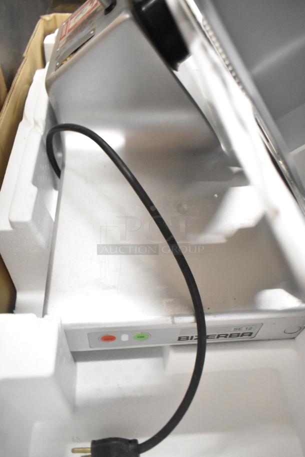 Bizerba SE 12 US stainless steel countertop meat slicer in original packaging. Features include 120 volts, 1 phase.
