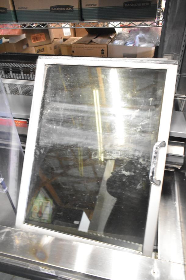 Metal commercial horizontal Grab N Go merchandiser with glass front, silver frame, sturdy handle, and visible wear.