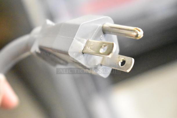 Close-up of a power plug from the Amana RCS10TS Stainless Steel Commercial Countertop Microwave Oven.