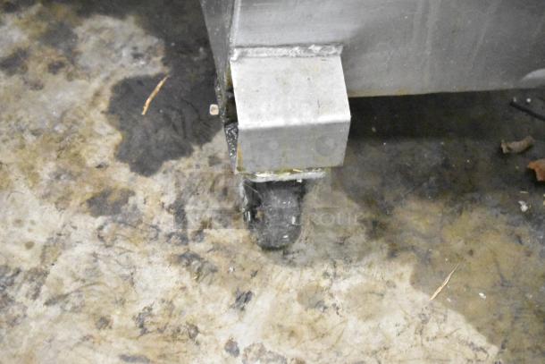 Close-up of the caster wheel on a 402 Metal Commercial Portable Fryer Oil Filter, showing its sturdy metal construction and mobility feature.