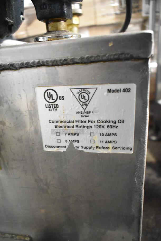 Metal commercial portable fryer oil filter, model 402, UL listed, 120 volts, 60Hz, visible wear and tear.