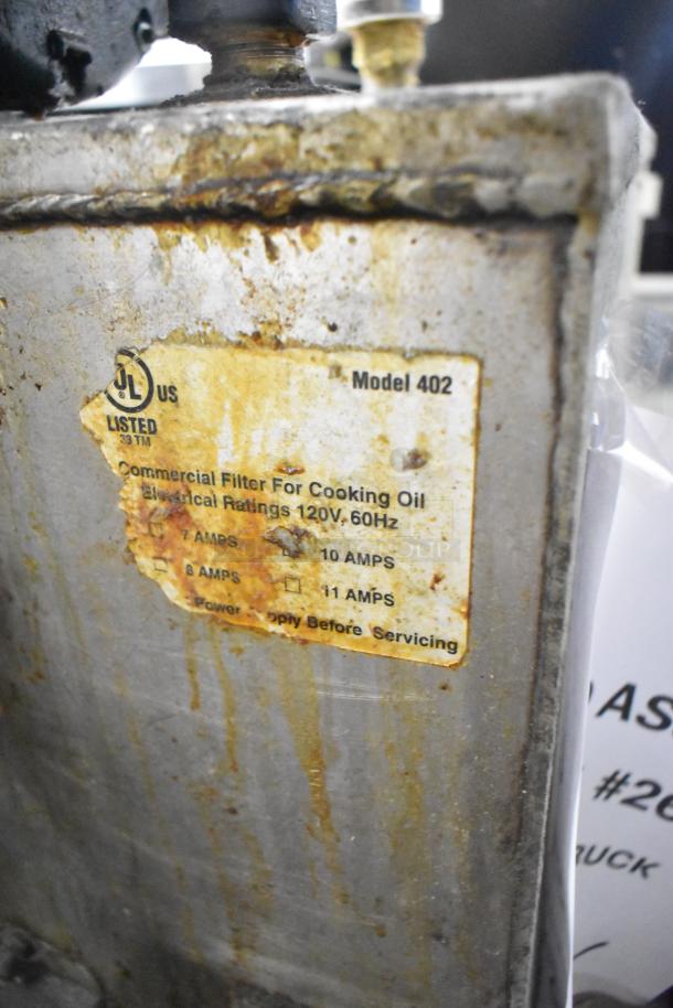 Metal Commercial Portable Fryer Oil Filter, Model 402, 120V, shows signs of wear and rust on label and exterior.