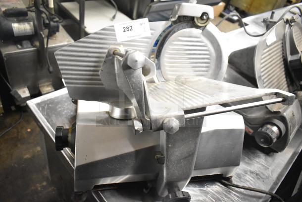 Stainless steel commercial meat slicer model 7510 with blade sharpener, 120 volts, 1 phase, on a metal countertop.