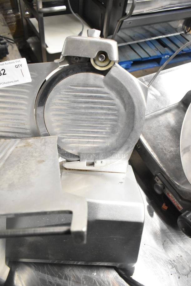 Stainless steel countertop meat slicer, model 7510, with blade sharpener. 120V, 1 Phase. Visible wear. Auction tag present.