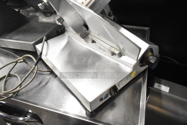Stainless steel commercial countertop meat slicer, model 7510, with blade sharpener. Shows signs of use, 120V, 1 phase.