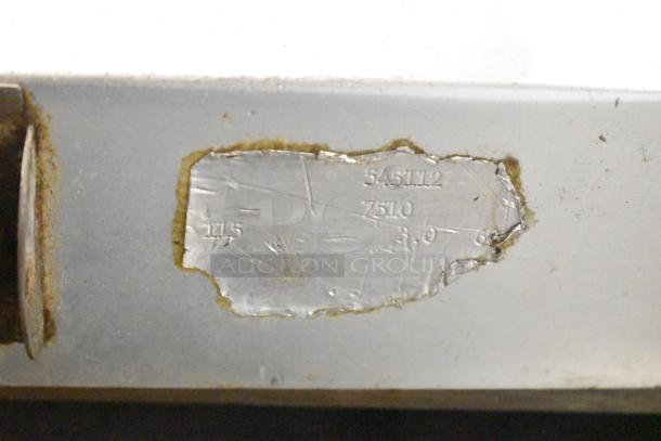 Metallic label with engravings showing model number 7510, possibly from a commercial countertop meat slicer.