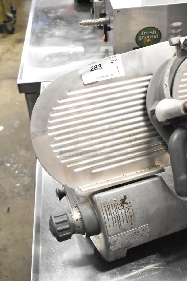 Hobart stainless steel commercial countertop meat slicer, 120 volts, 1 phase, adjustable thickness dial, visible labels and markings.