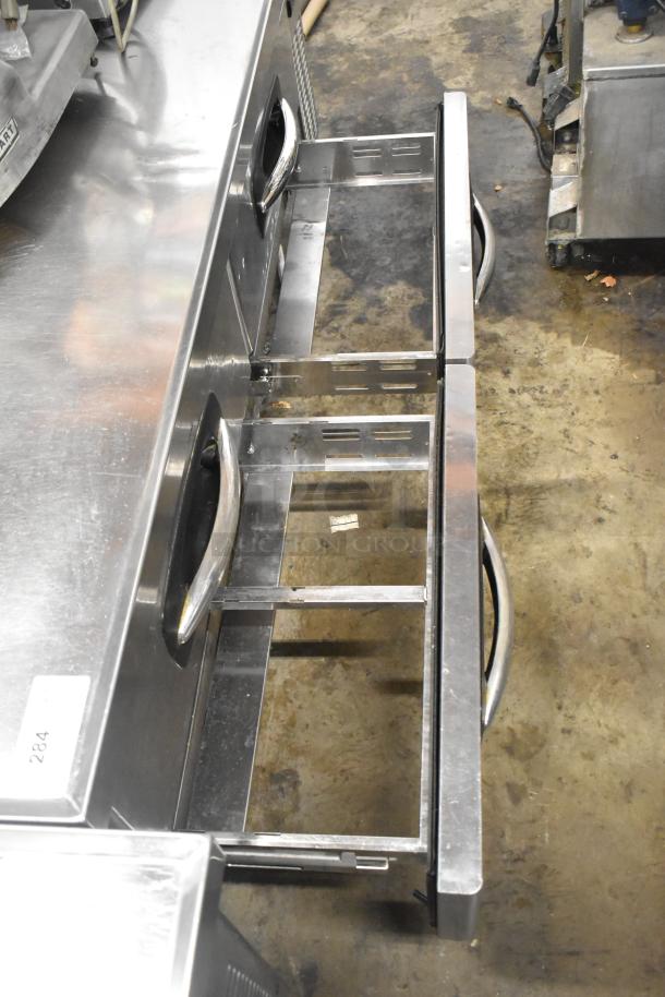 Stainless steel 4-drawer chef base on casters, 115V, 1 phase; industrial condition with open drawers.