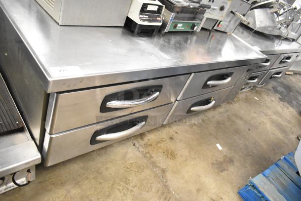 Stainless steel 4-drawer chef base on commercial casters, 115 volts, 1 phase. Features durable handles, good condition.