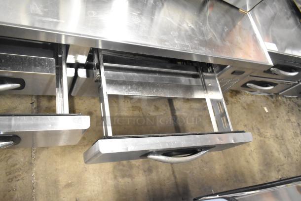 Stainless steel 4-drawer chef base on commercial casters, 115 volts, 1 phase, featuring durable construction and easy mobility.