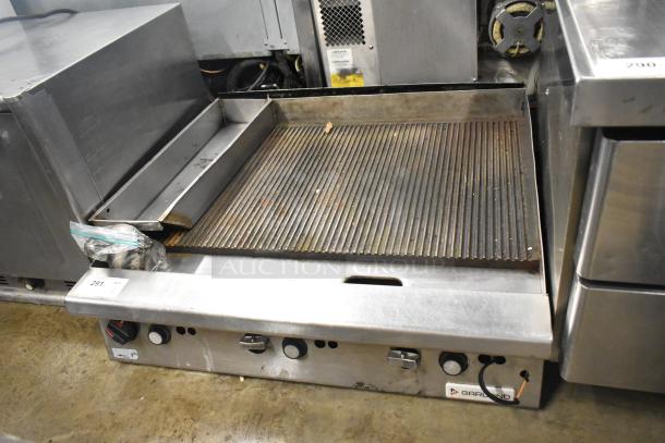 Garland stainless steel commercial countertop gas griddle with ridged surface, visible controls, and attached grease trap. Used condition.
