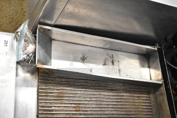 Garland stainless steel commercial gas-powered ridged griddle, countertop model. Visible wear in cooking area. Auction tag 291.