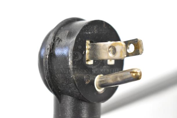 Close-up of a power plug for Beverage Air SM34N-W Commercial Milk Cooler. Black with visible prongs and minor wear.