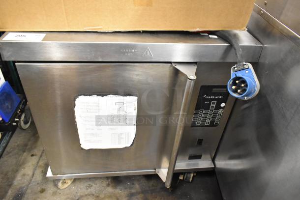 Garland stainless steel commercial electric half-size convection oven with solid door, metal racks, and commercial casters.
