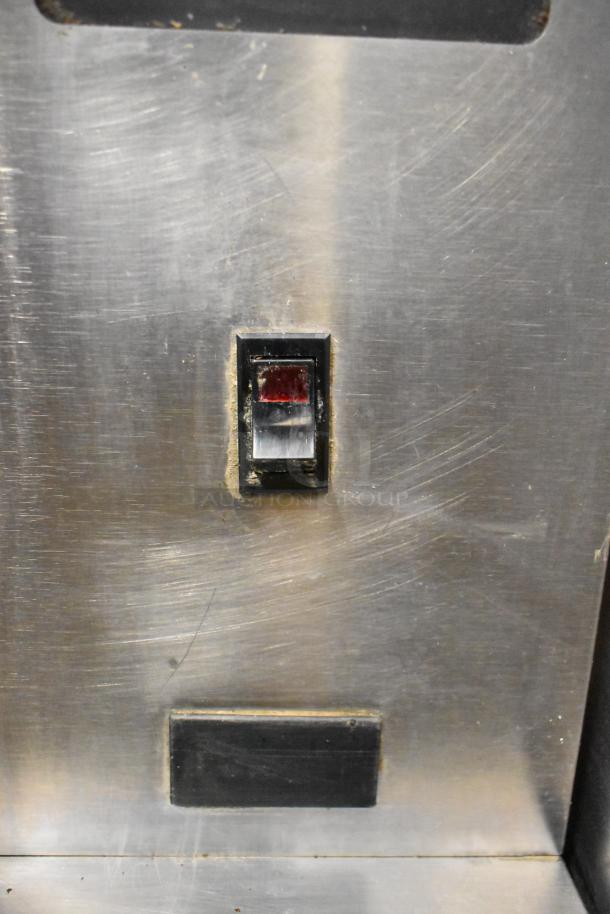 Garland stainless steel half-size convection oven, electric powered, solid door. Features metal racks, commercial casters.