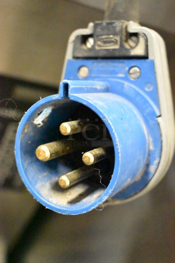 Close-up of a blue industrial power plug for a Garland stainless steel electric convection oven.