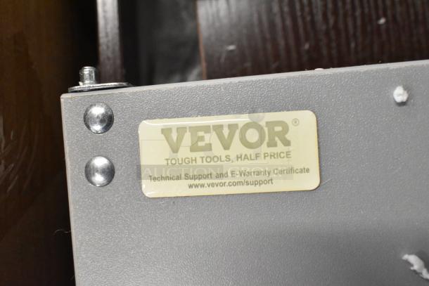 Vevor label on a gray surface, reads "TOUGH TOOLS, HALF PRICE" with technical support link, bolted with metal screws.