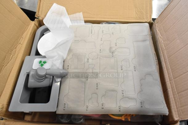 Cardboard box containing cuttable fake toy food parts, labeled with shape templates and an attached tool, in good condition.
