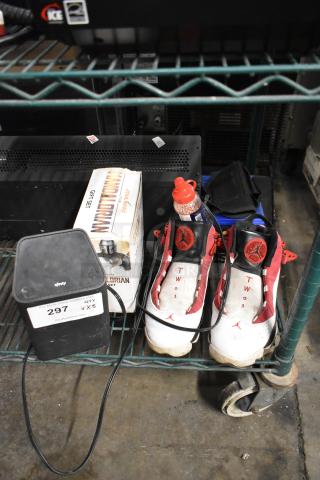 8-item auction lot: Xfinity router, Star Wars Mandalorian mug, size 8 Jordan sneakers, BB gun BBs, Batman DVD, XG2v2-P box.