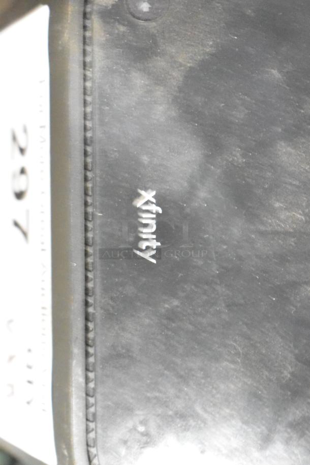 Xfinity router with visible branding, part of a lot including Star Wars mug, Jordan sneakers, BB gun BBs, Batman DVD, XG2v2-P box.