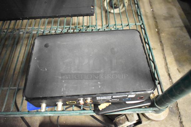 Xfinity XG2v2-P box in used condition on a shelf. Visible ports include HDMI, coaxial; minor surface wear.