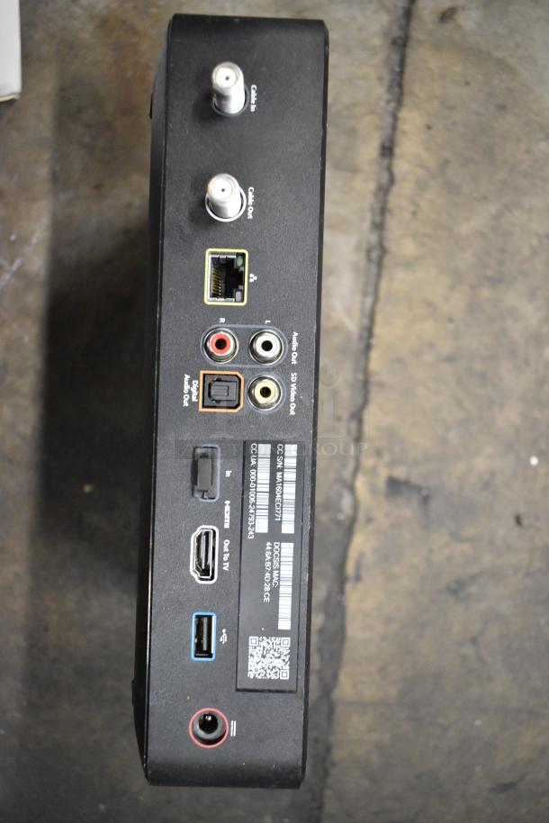 Back view of an Xfinity router showing various ports and labels, including Ethernet, HDMI, USB, and audio connections.