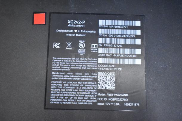 Close-up of XG2v2-P Xfinity box label, showing serial numbers, FCC compliance, and Dolby license info.