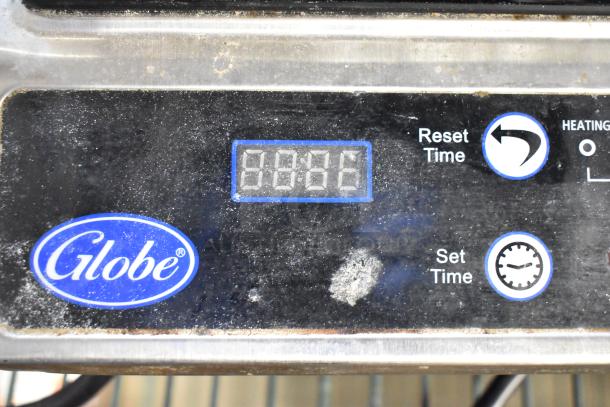 Globe IR1800 induction range control panel with digital display and logo. Shows power and timer settings.