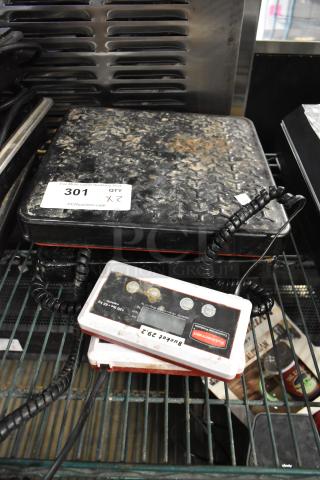 2 Rubbermaid 150 lb capacity scales, model 4010-88, with digital displays. Noted wear on surfaces. Auction tag indicates 2.