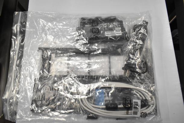 Epson J252A Photo Scanner, new in packaging with power and USB cables. Model and safety labels visible.