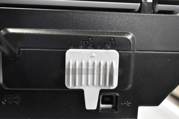 Epson J252A Photo Scanner, black casing, close-up of locking mechanism and USB port, DC 24V label visible.