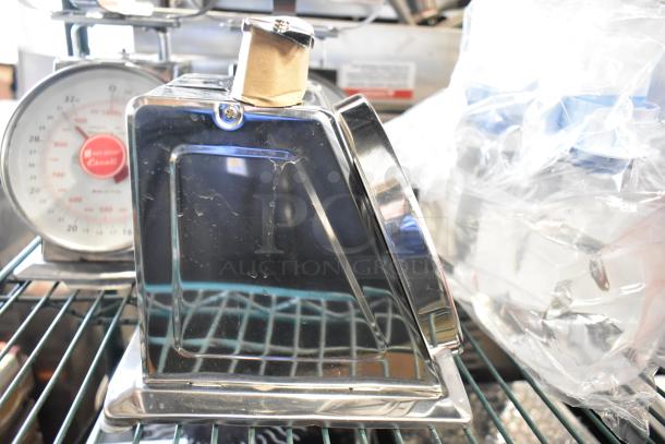 Three vintage metal countertop scales, featuring a polished finish and dial display, in good condition for auction.
