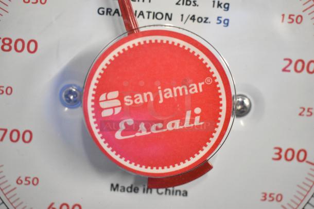 San Jamar Escali metal countertop scale, red dial, measures up to 2 lbs/1 kg. Made in China, in good condition.