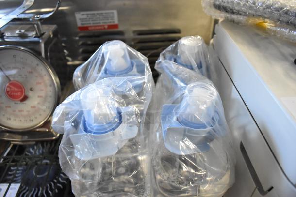 Four sealed bottles of hand sanitizer foam, wrapped in plastic. Clean, unused condition.