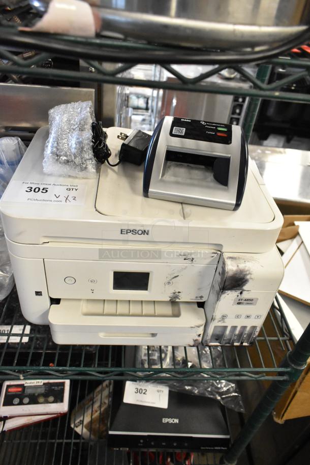 Epson ET-4850 printer and AccuBanker D450 counterfeit bill detector, both showing signs of wear. Auction tag indicates 2 items.