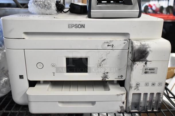 Epson ET-4850 printer with visible ink marks and AccuBanker D450 counterfeit bill detector. Auction for two items.