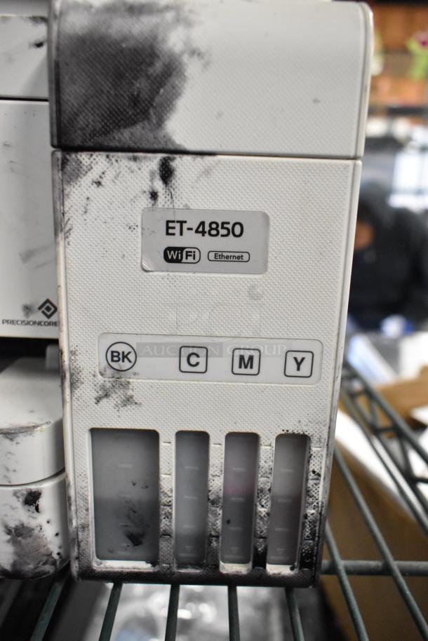 Epson ET-4850 Printer showing ink levels, WiFi and Ethernet labels, visible ink smudges on surface.