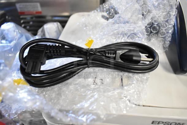 Epson ET-4850 Printer and AccuBanker D450 Detector, both in bubble wrap. Power cord shown. Printer partially visible.
